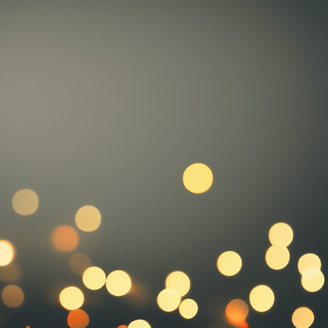 Warm hue bokeh lights on Grey background Free Stock Image
